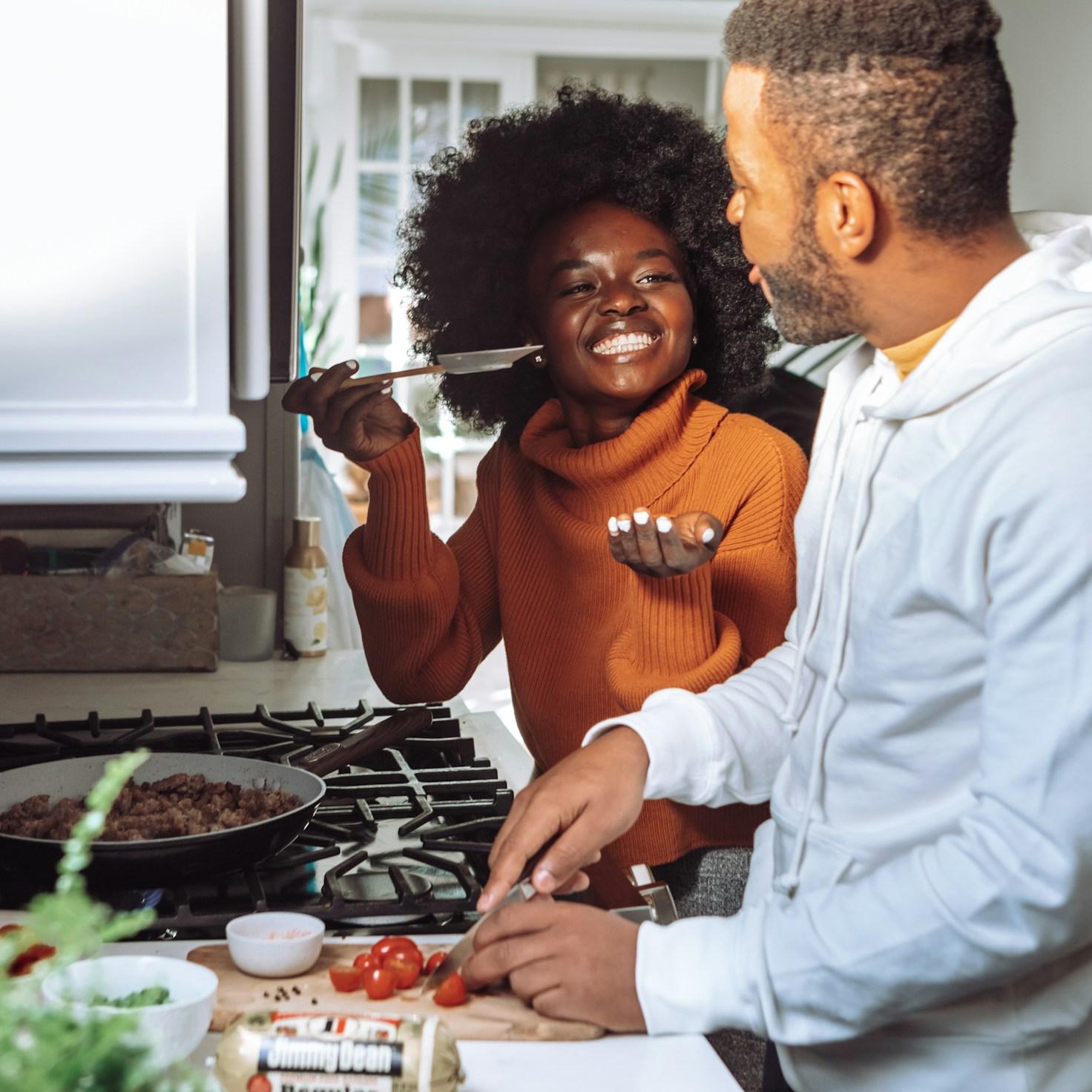 Community members collaborating in a modern kitchen space, sharing recipes and cooking techniques